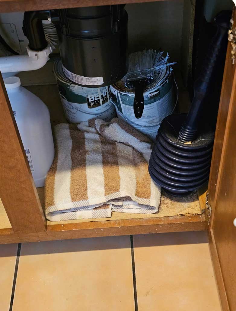 Remove paint Cans,Remove towel,find leak and replace cupboard floorpanel